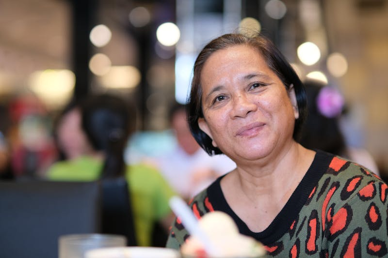 Friendly front-of-house team member smiling at the restaurant